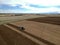 Blue Farm Tractor Plowing Large Farm Field