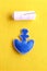 Blue felt anchor ornament and white thread on yellow wool background. Edges of the toy joined using beautiful blanket stitch. Step