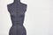 Blue female sewing mannequin on gray background, front view, cop