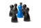 Blue figure in the middle of a group. Other figures blurred. Business concept for leadership, teamwork or groups