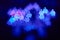 Blue figures bokeh in the form of piglets on the background of a led light
