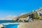 Blue fishermans boat and evergreen tamarisks on Alexi or Alexis beach near Emborios Greek village on Kalymnos island