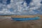 Blue fishing boat named `Let me live`, `Deixe me viver`, by low tide at Ponta do Muta beach in Barra Grande, Brazil, South America