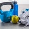 Blue fitness accessories with still-life of sneakers and kettle bell