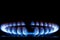 The blue flame of the gas burner of the kitchen stove in the dark. Place under the text