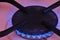 A blue flame from a gas cooktop burner. Stove turbo burner with burning flame closeup