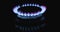 Blue flame of gas stove on black background. Kitchen burner turning on. Natural gas inflammation