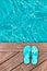 Blue flip flops on a wooden deck