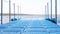 Blue floating plastic pontoon pier with rope railings rocking on waves at lake or river beach. Dock for small boats and