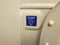 Blue flush button in airplane restroom or bathroom