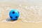 Blue football on beach