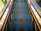 Blue footprints mark on escalator stair.