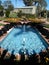 Blue fountain water and shadows in a botanical garden in California