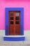 Blue framed door and pink wall