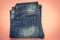 Blue frayed jeans with a pocket, folded shabby pants on a pink background. Dark denim