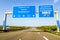 Blue freeway sign over the road in Germany on sunny day