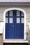 Blue Front entry double doors next to shake siding
