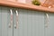 Blue front of kitchen cabinet with graceful handles. Part of modern kitchen interior close-up. Modern cuisine. Cabinet handle.