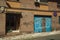 Blue garage gate on a brick building facade at Caceres