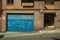 Blue garage gate and door on a brick building at Caceres