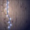 Blue garland with light bulbs on a wooden background.