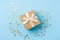 a blue gift box with golden ribbons on a blue background. It is an ideal image to illustrate celebration topics, Generative AI