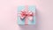 Blue gift box with shiny pink satin ribbon bow on pink background, Valentines day and Mothers day present concept. generative ai