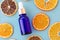 Blue glass bottle with pipette filled by essence or serum with vitamin C on blue background