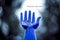 Blue glass hand reaching up to the sky with saying