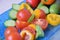 A blue glass plate with bright multicolor vegetables