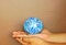 Blue globe on both hands, background, brown wall, light, support the world, cared world, push the world, the world environment,