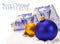 Blue and gold Christmas balls and ribbon in snow