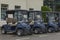 Blue golf buggies parked up in a row at the golf course