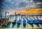 Blue gondolas by the shore in Venice