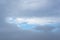 Blue-gray clouds in the sky before the rain. Light blue sky behind dark and dramatic storm clouds.