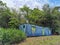 A Blue and Green Abandoned Container