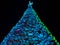 Blue-green illuminated Christmas tree made of wood