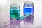 Blue and Green Liquid Glass Containers
