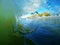 A Blue and Green Ocean Wave Breaks Near the Beach