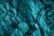 Blue green rock texture. Toned the rough surface of the mountain. Close-up. Dark teal stone background with space for design.