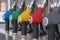 Blue, green, yellow, red and gray fuel pistols on fuel station close-up