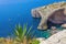 Blue Grotto rock cliff arch in Malta, aerial view from the Mediterranean Sea to the island