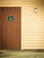 Blue handicapped wheelchair sign on door of public toilet