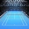 Blue hard surface tennis court and stadium full of spectators with spotlights