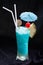 Blue Hawaii cocktail Tall glass with umbrella with pineapple and red cherries.Suitable for drinking for refreshing, quenching