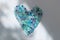 Blue heart made of natural tourmaline stones. Unusual surreal design