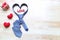 Blue heart necktie and gift box with red ribbon and handmade crochet heart on wood background for happy fathers day