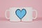 Blue heart and two cups on pink background. Valentine`s day, love, wedding concept