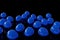 Blue helium balloons on floor, black background