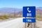 Blue help 911 sign post on Route 40 in Salta Province, Argentina
